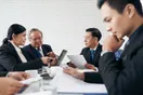 A small legal team working together around a conference table in a law office, in a natural documentary style.
