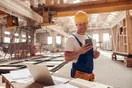 A phone on a tripod filming a kitchen remodel in progress, framed as a construction Instagram shoot, in a documentary style.