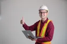 A construction contractor filming a jobsite walkthrough on a phone mounted to a gimbal, in a natural documentary style.