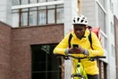 A delivery business owner checking a Google Maps search result for local couriers on a phone, in a natural documentary style.