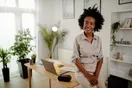 An accountant shaking hands with a local business banker in a small office, documentary style, warm daylight.