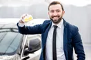 An exterior conveyor car wash tunnel with a car moving through the foam arches, shot in a natural documentary style.