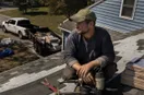 A roofing contractor unlocking the door of a small shop for the first time at golden hour, in a natural documentary style.