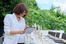 A home cook packing prepared trays into insulated carriers for a first paid event, in a natural documentary style.